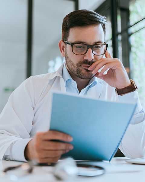 Medical Resident, a white man with glasses and beard, reviews his career assessment from PS&D.